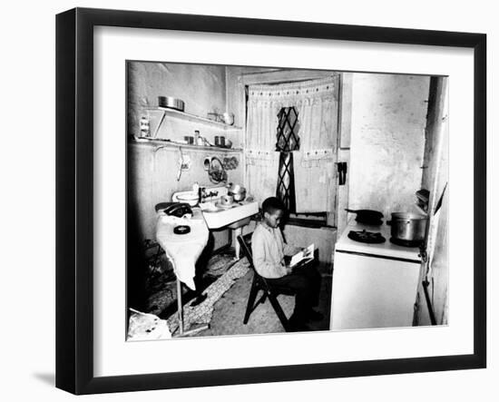 Young African American Studies by Kitchen Stove Because His Apartment Is Without Heat-null-Framed Photo