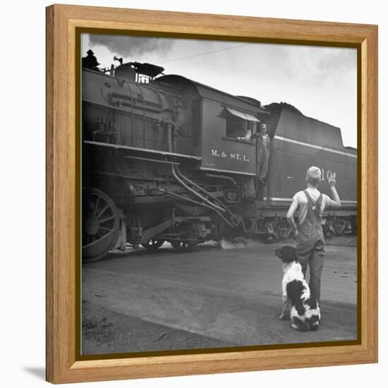 Young Boy and His Dog Standing at the Crossing as a Train Rides Through-Myron Davis-Framed Premier Image Canvas