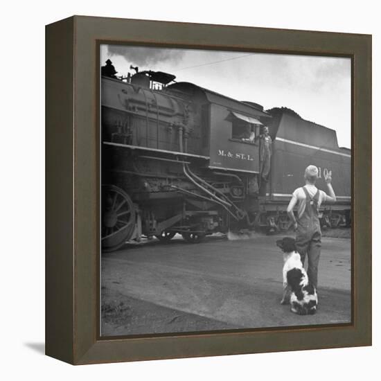 Young Boy and His Dog Standing at the Crossing as a Train Rides Through-Myron Davis-Framed Premier Image Canvas