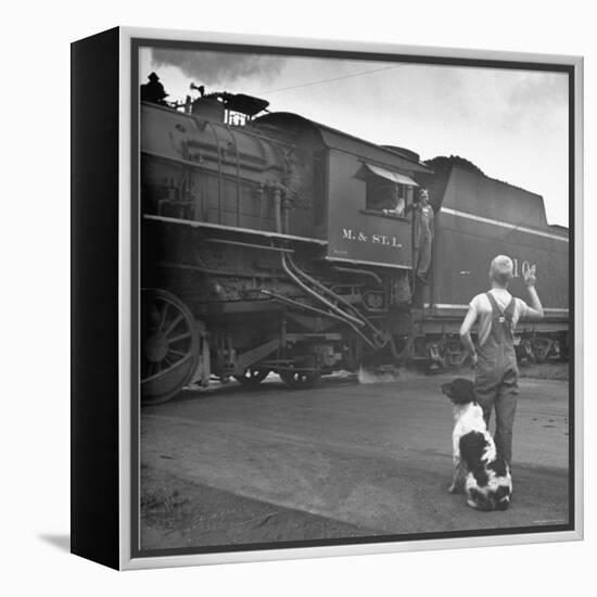 Young Boy and His Dog Standing at the Crossing as a Train Rides Through-Myron Davis-Framed Premier Image Canvas