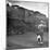 Young Boy and His Dog Standing at the Crossing as a Train Rides Through-Myron Davis-Mounted Photographic Print