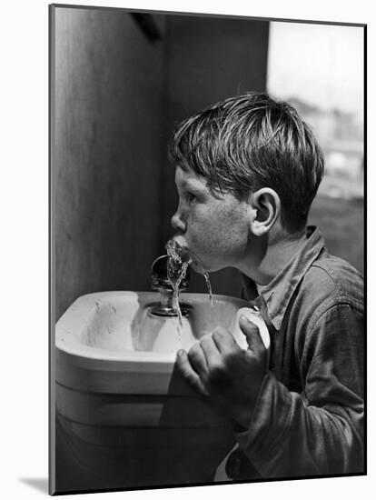 Young Boy Drinking from a Water Fountain-Allan Grant-Mounted Photographic Print