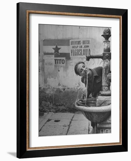 Young Boy Getting a Drink from Fountain in Trieste Region-Nat Farbman-Framed Photographic Print