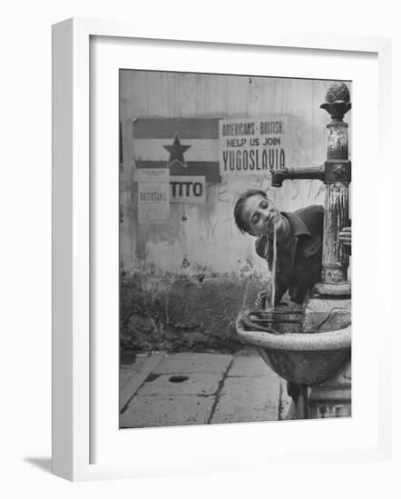 Young Boy Getting a Drink from Fountain in Trieste Region-Nat Farbman-Framed Photographic Print