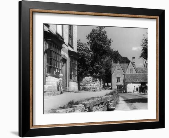 Young boy looking in shop window in the Cotswolds, 1935-Bernard Alfieri-Framed Photographic Print