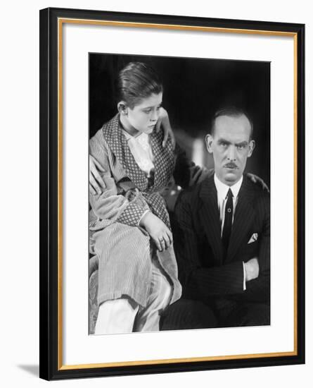 Young Boy Looking Worried at His Father-null-Framed Photo