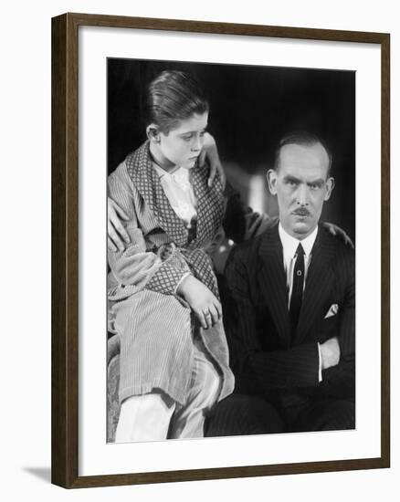 Young Boy Looking Worried at His Father-null-Framed Photo