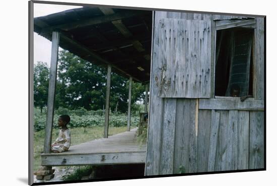 Young Boy on the Porch and a Second Boy Looking Out of Window, on Edisto Island, South Carolina-Walter Sanders-Mounted Photographic Print