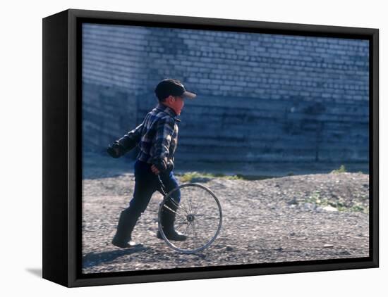 Young Boy Playing on the street of Uelen, Russia's Far East, Siberia-Daisy Gilardini-Framed Premier Image Canvas