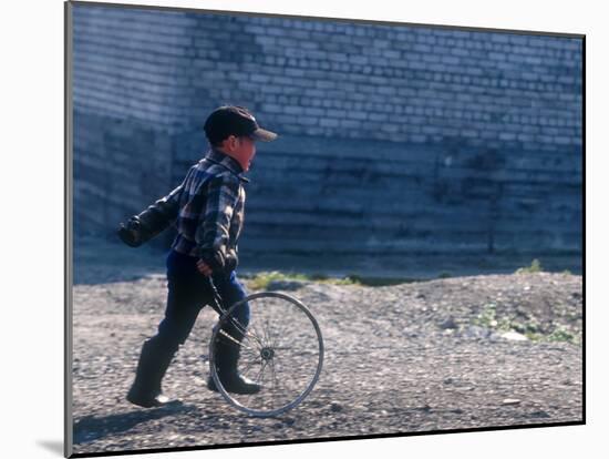 Young Boy Playing on the street of Uelen, Russia's Far East, Siberia-Daisy Gilardini-Mounted Photographic Print
