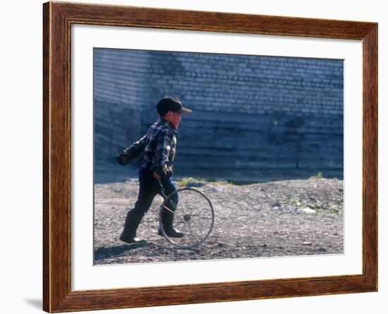 Young Boy Playing on the street of Uelen, Russia's Far East, Siberia-Daisy Gilardini-Framed Photographic Print