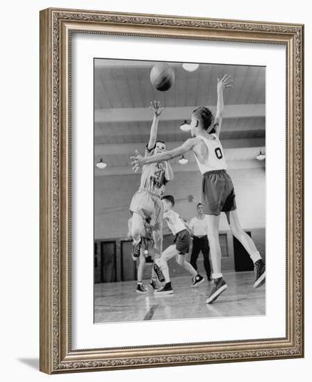 Young Boy Shooting a Free-Throw Shot over the Head of Another Young Boy-null-Framed Photographic Print