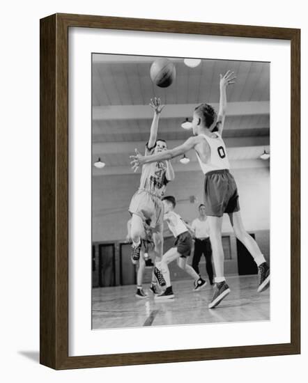 Young Boy Shooting a Free-Throw Shot over the Head of Another Young Boy-null-Framed Photographic Print