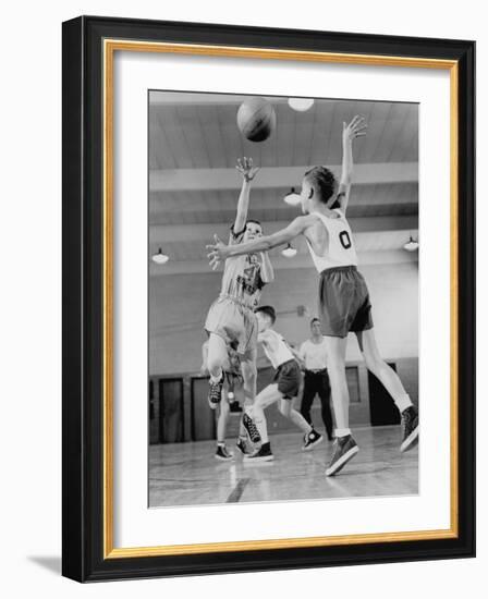 Young Boy Shooting a Free-Throw Shot over the Head of Another Young Boy-null-Framed Photographic Print