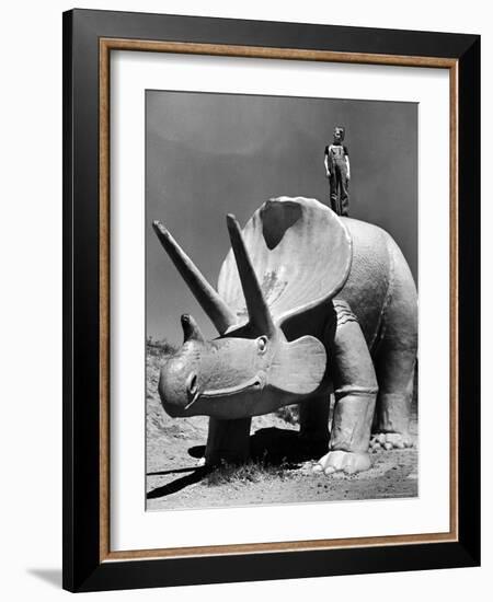 Young Boy Standing Atop Large Statue of Dinosaur in "Dinosaur Park" Tourist Attraction-Alfred Eisenstaedt-Framed Photographic Print