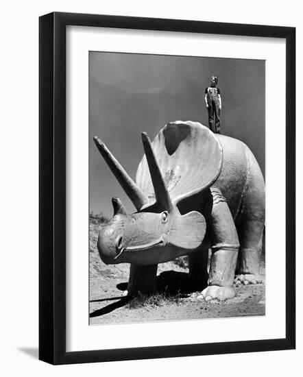 Young Boy Standing Atop Large Statue of Dinosaur in "Dinosaur Park" Tourist Attraction-Alfred Eisenstaedt-Framed Photographic Print