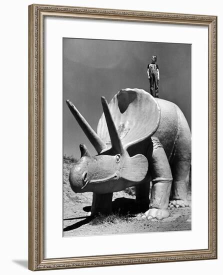 Young Boy Standing Atop Large Statue of Dinosaur in "Dinosaur Park" Tourist Attraction-Alfred Eisenstaedt-Framed Photographic Print