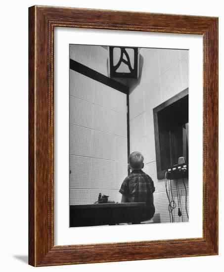 Young Boy Starring at the Loudspeaker Trying to Hear During a Medical Deafness Test-John Dominis-Framed Photographic Print