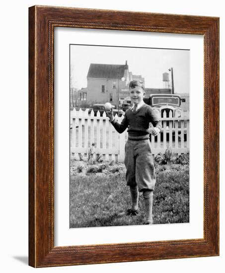 Young Boy Tosses a Baseball in His Backyard, Ca. 1936.-Kirn Vintage Stock-Framed Photographic Print