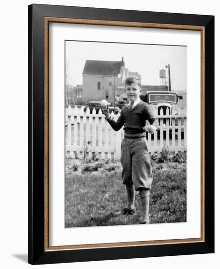 Young Boy Tosses a Baseball in His Backyard, Ca. 1936.-Kirn Vintage Stock-Framed Photographic Print