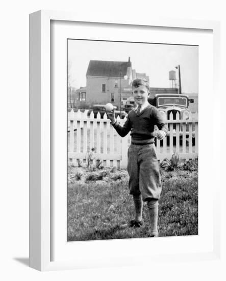 Young Boy Tosses a Baseball in His Backyard, Ca. 1936.-Kirn Vintage Stock-Framed Photographic Print