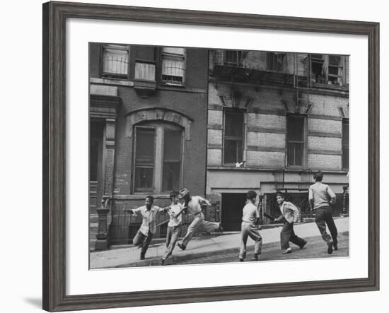 Young Boys with Sticks, Running Around While Playing a Street Game in Spanish Harlem-Ralph Morse-Framed Photographic Print