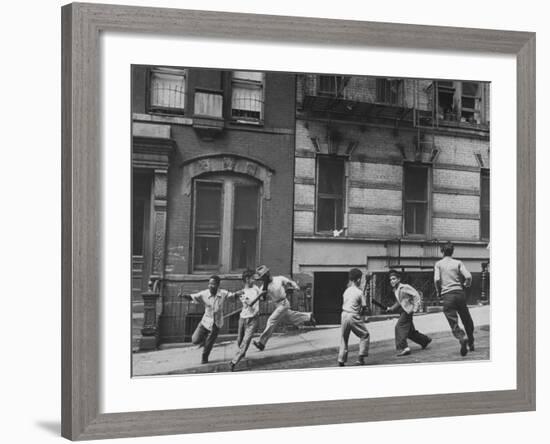 Young Boys with Sticks, Running Around While Playing a Street Game in Spanish Harlem-Ralph Morse-Framed Photographic Print