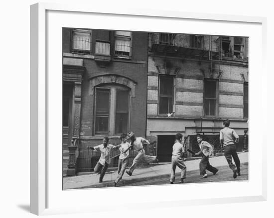 Young Boys with Sticks, Running Around While Playing a Street Game in Spanish Harlem-Ralph Morse-Framed Photographic Print