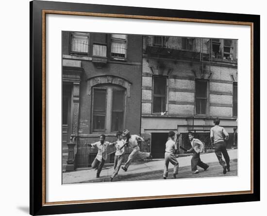 Young Boys with Sticks, Running Around While Playing a Street Game in Spanish Harlem-Ralph Morse-Framed Photographic Print