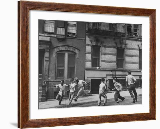 Young Boys with Sticks, Running Around While Playing a Street Game in Spanish Harlem-Ralph Morse-Framed Photographic Print