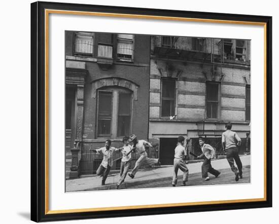 Young Boys with Sticks, Running Around While Playing a Street Game in Spanish Harlem-Ralph Morse-Framed Photographic Print