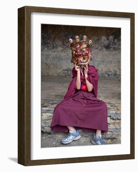 Young Buddhist Monk Holding Traditional Carved Wooden Mask to His Face at the Tamshing Phala Choepa-Lee Frost-Framed Photographic Print