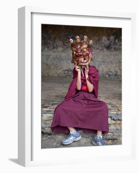 Young Buddhist Monk Holding Traditional Carved Wooden Mask to His Face at the Tamshing Phala Choepa-Lee Frost-Framed Photographic Print