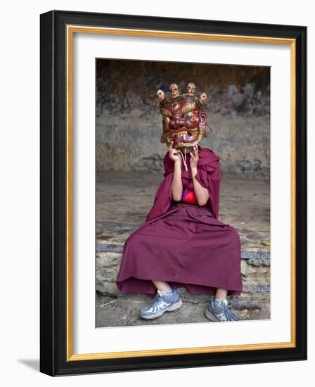 Young Buddhist Monk Holding Traditional Carved Wooden Mask to His Face at the Tamshing Phala Choepa-Lee Frost-Framed Photographic Print