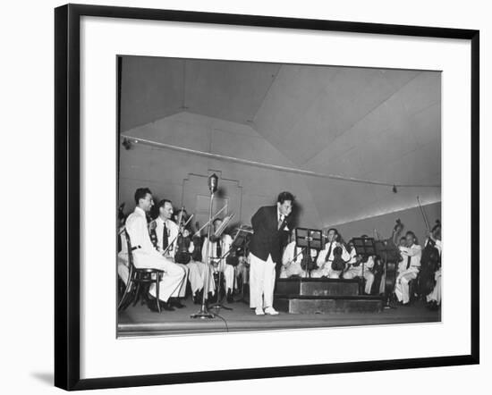 Young Conductor Lorin Maazel Taking a Bow at a Concert by the Robin Hood Dell Orchestra-Nina Leen-Framed Premium Photographic Print