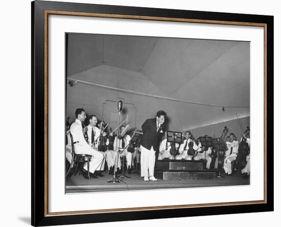 Young Conductor Lorin Maazel Taking a Bow at a Concert by the Robin Hood Dell Orchestra-Nina Leen-Framed Premium Photographic Print