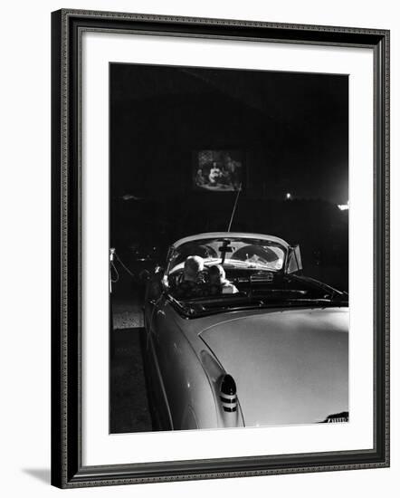 Young Couple Cuddling as They Watch a Movie at Drive in Theater-Francis Miller-Framed Photographic Print