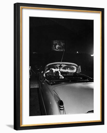 Young Couple Cuddling as They Watch a Movie at Drive in Theater-Francis Miller-Framed Photographic Print