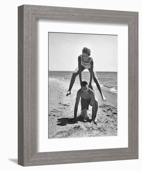 Young Couple Playing Leapfrog on the Beach-The Chelsea Collection-Framed Premium Giclee Print