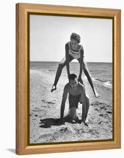 Young Couple Playing Leapfrog on the Beach-The Chelsea Collection-Framed Stretched Canvas