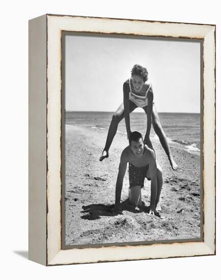 Young Couple Playing Leapfrog on the Beach-The Chelsea Collection-Framed Stretched Canvas