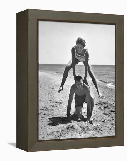 Young Couple Playing Leapfrog on the Beach-The Chelsea Collection-Framed Stretched Canvas