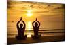 Young Couple Practicing Yoga On The Sea Beach At Sunset-De Visu-Mounted Art Print