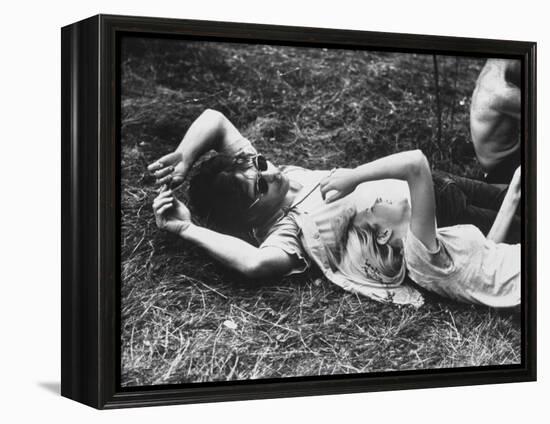 Young Couple Relaxing During Woodstock Music Festival-Bill Eppridge-Framed Premier Image Canvas