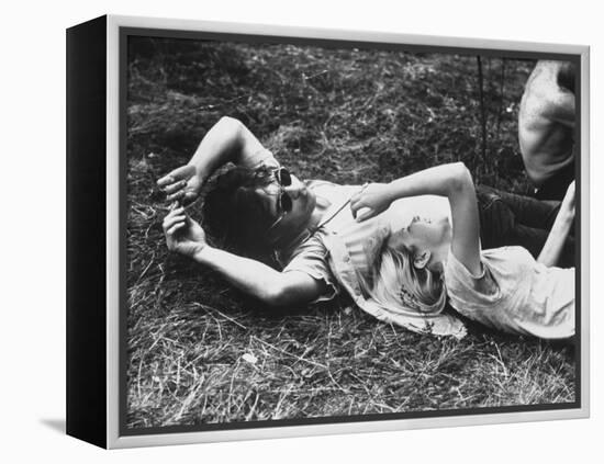 Young Couple Relaxing During Woodstock Music Festival-Bill Eppridge-Framed Premier Image Canvas