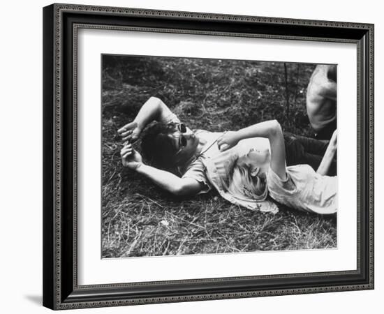 Young Couple Relaxing During Woodstock Music Festival-Bill Eppridge-Framed Photographic Print