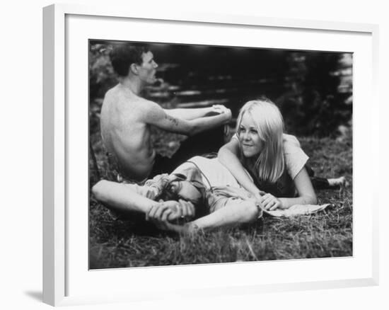 Young Couple Relaxing During Woodstock Music Festival--Framed Photographic Print