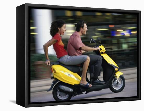 Young Couple Riding on a Motor Scooter-null-Framed Premier Image Canvas