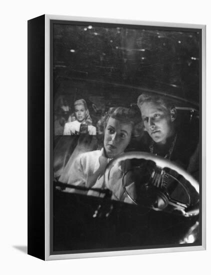 Young Couple Snuggling in Convertible as They Intently Watch Movie at Drive-in Movie Theater-J^ R^ Eyerman-Framed Premier Image Canvas