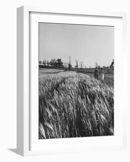 Young Couple Walking by a Grain Field-Ed Clark-Framed Photographic Print